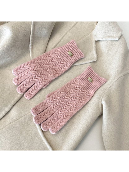 Pink five-finger gloves with a repeating chevron knit pattern