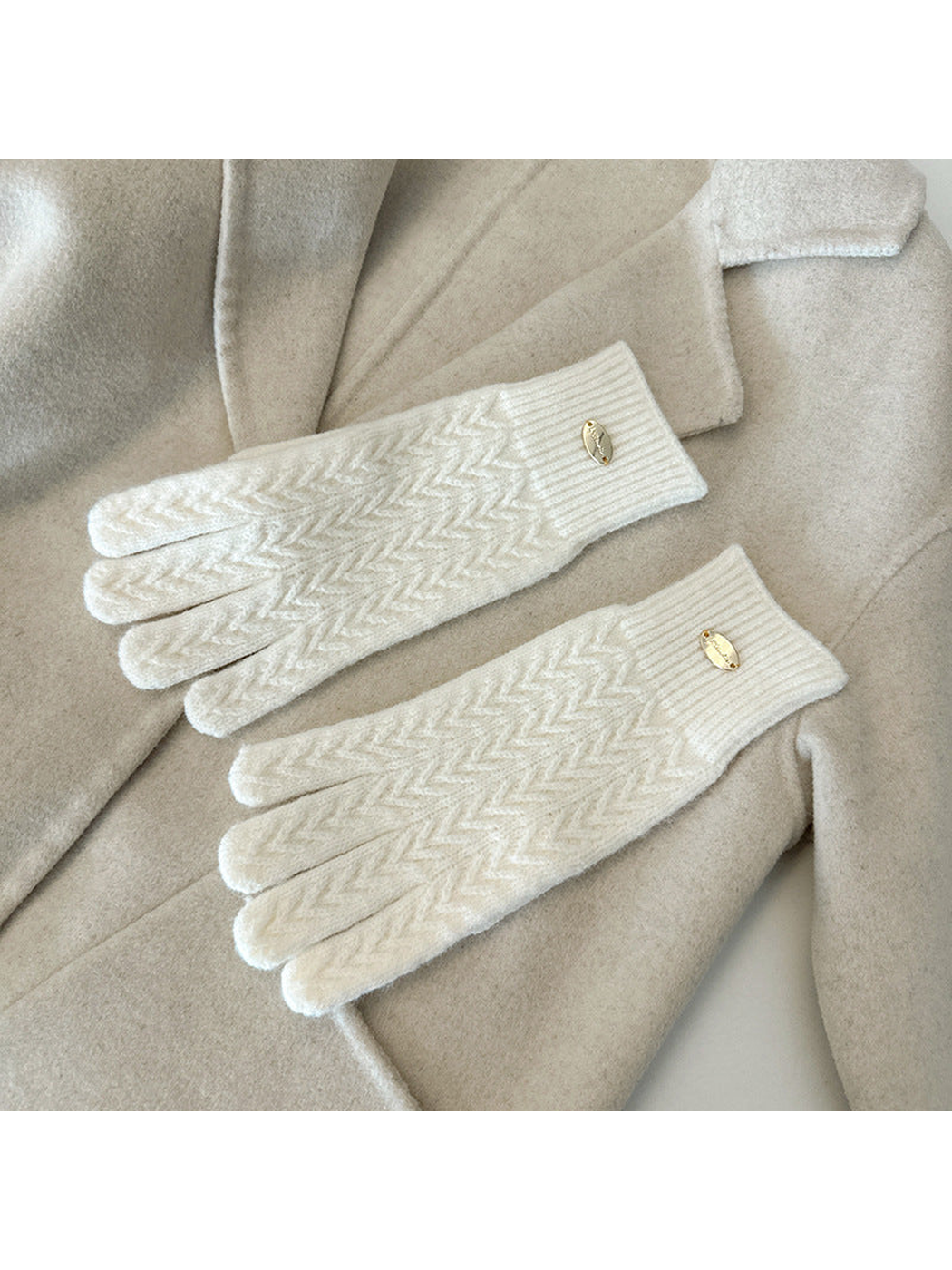 Ivory five-finger gloves with a repeating chevron knit pattern