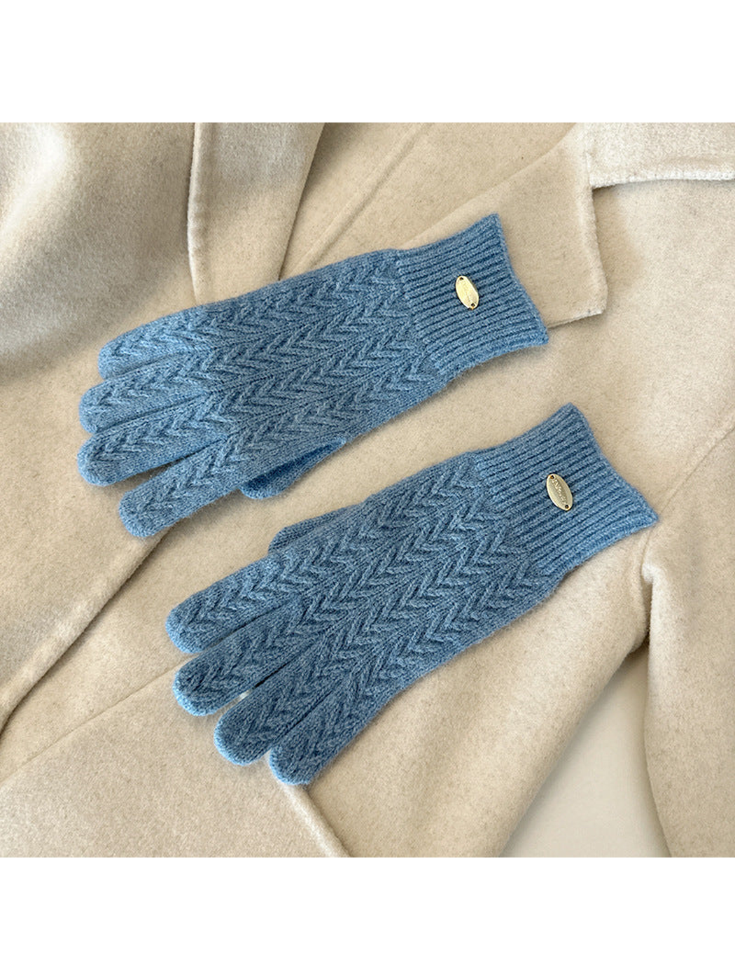 Light Blue five-finger gloves with a repeating chevron knit pattern