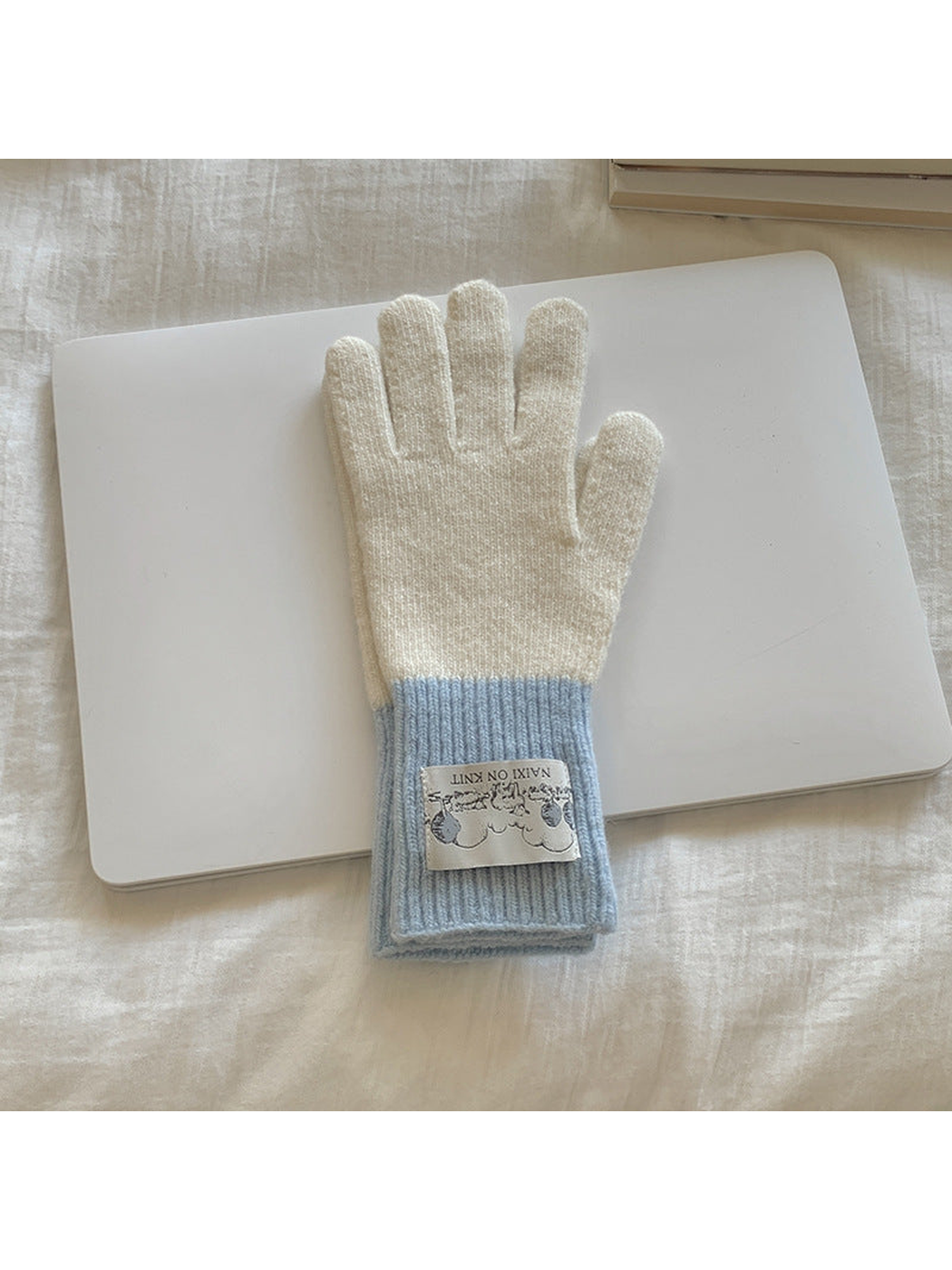 White gloves with light blue cuffs, front view