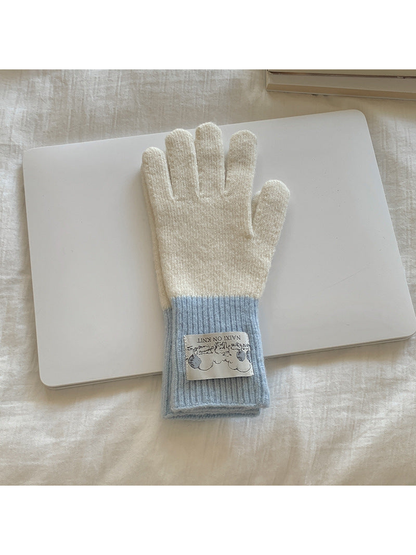 White gloves with light blue cuffs, front view
