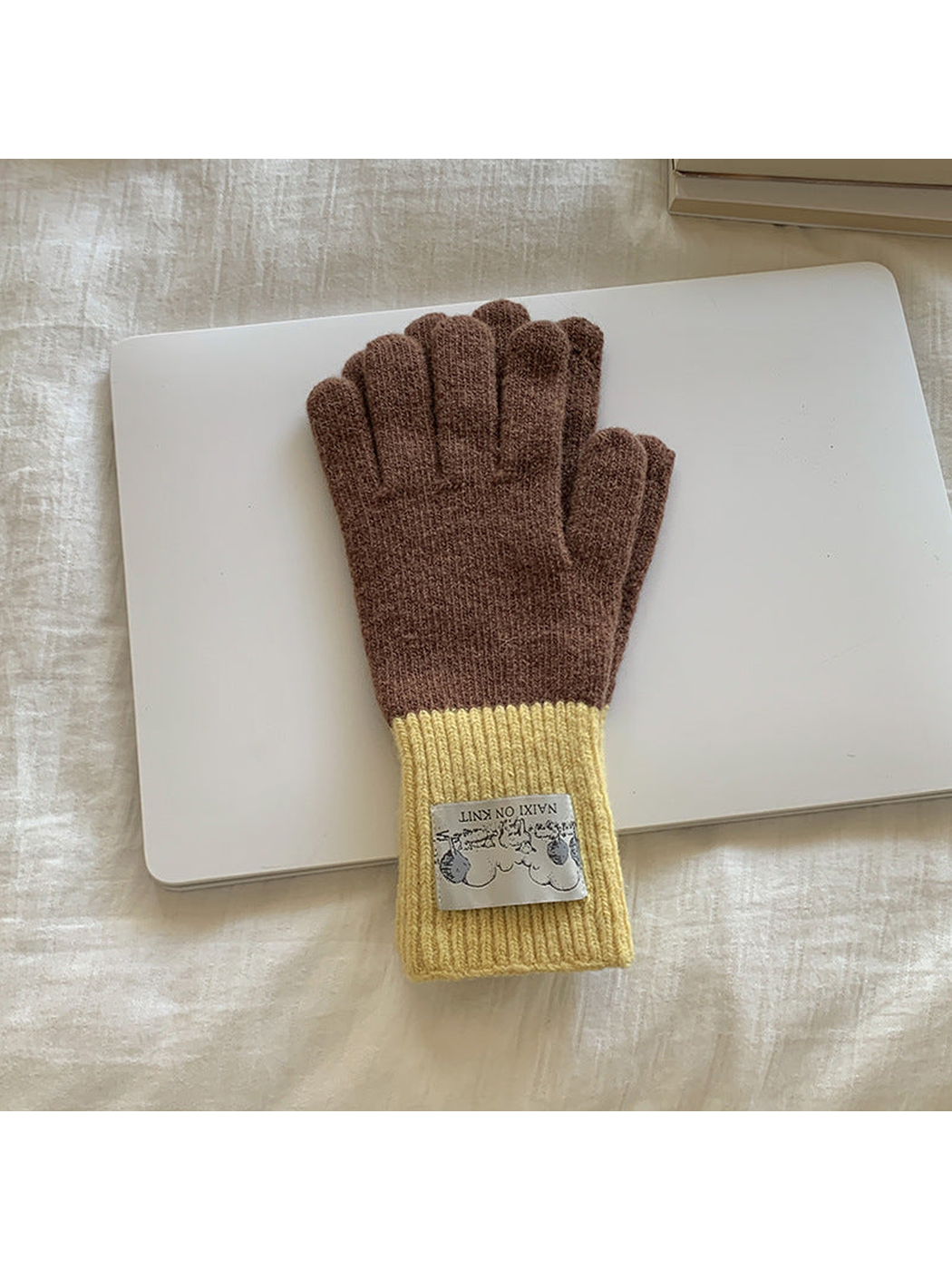 Brown gloves with yellow cuffs, front view