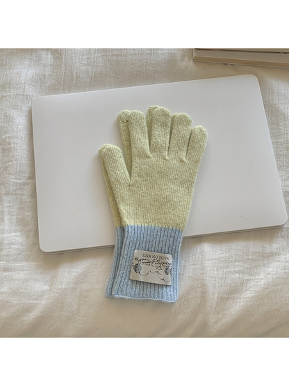 Beige gloves with light blue cuffs, front view