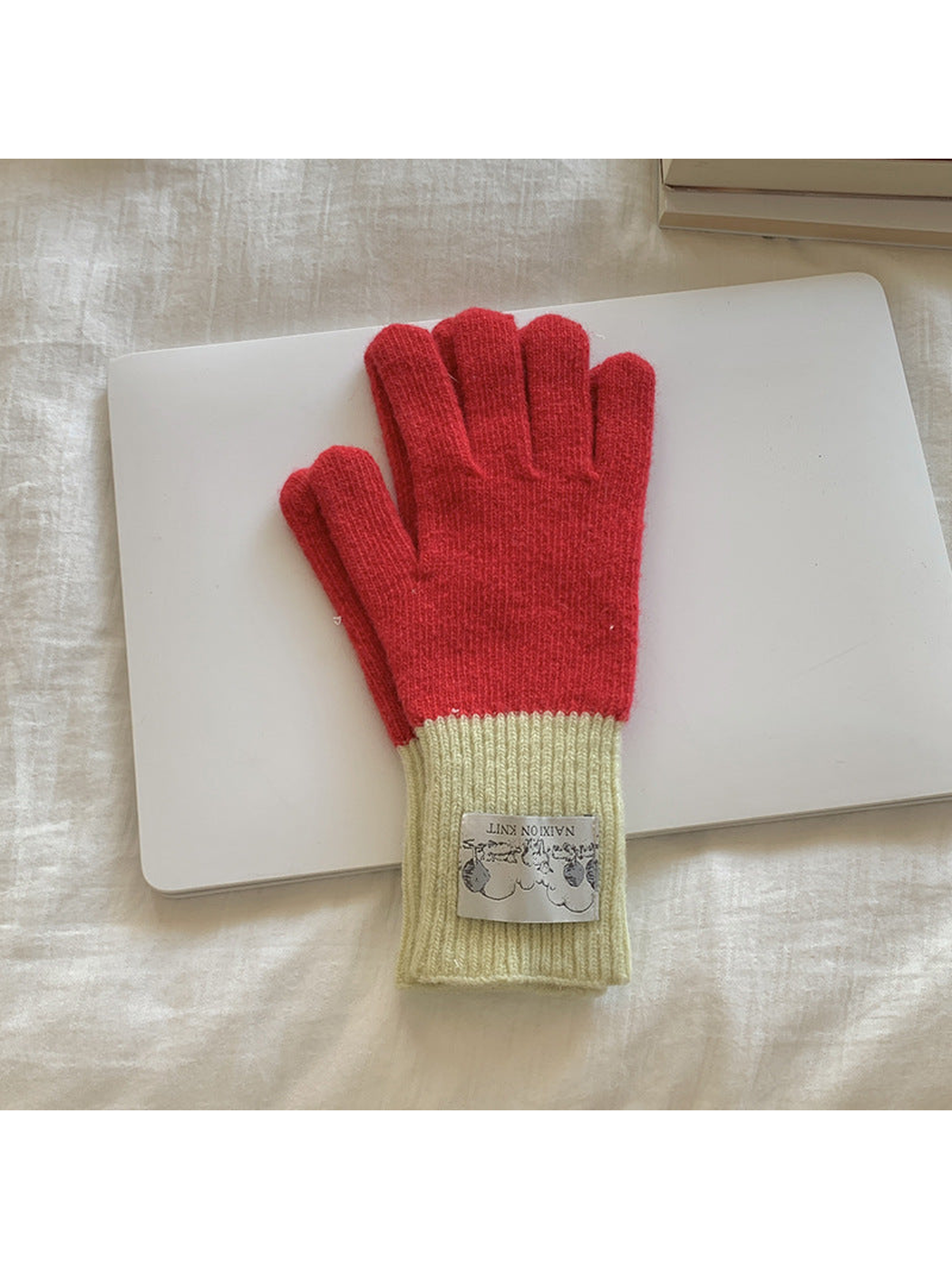 Red gloves with cream cuffs, front view