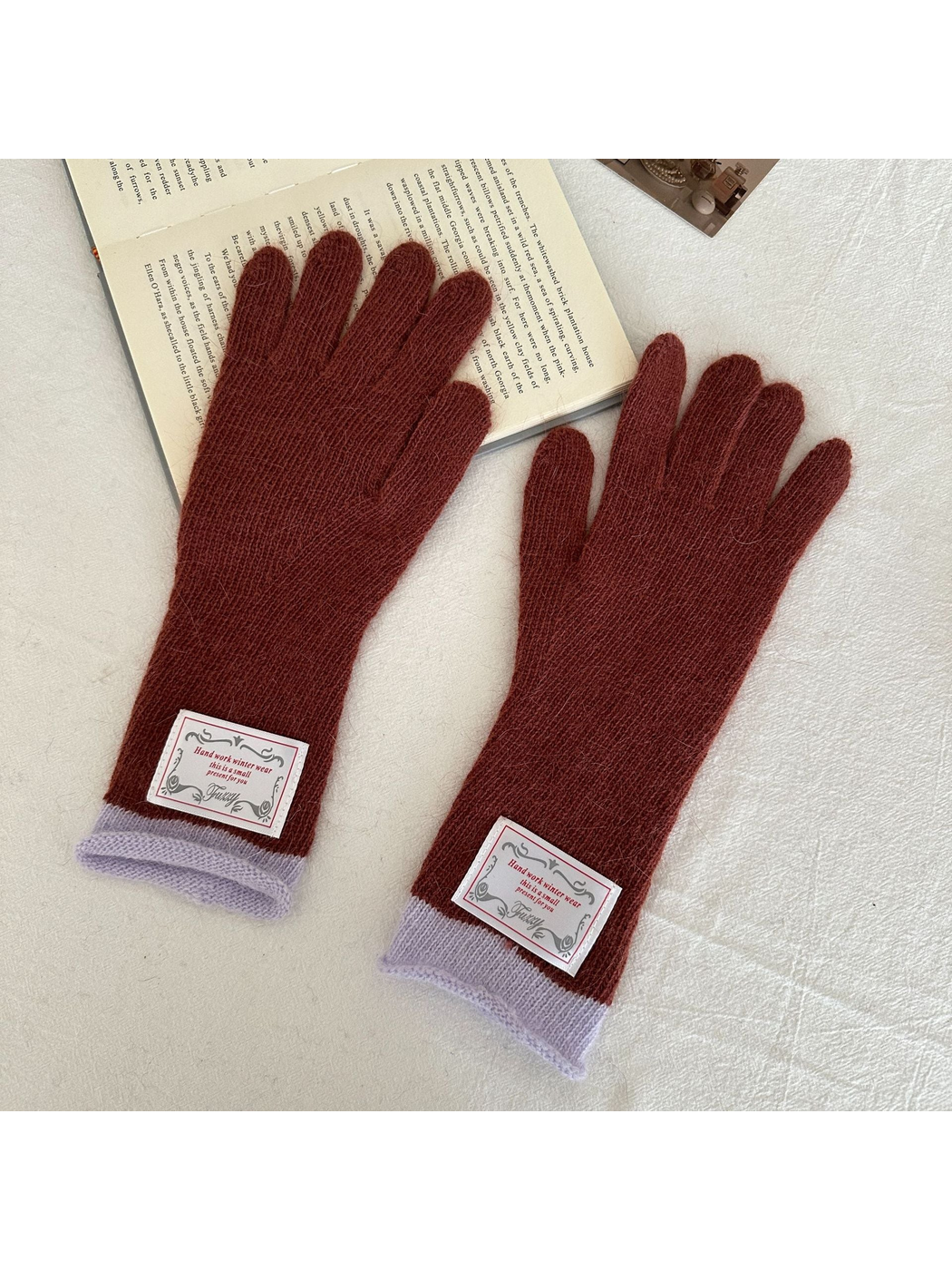 Burgundy gloves with light-purple ribbed cuffs