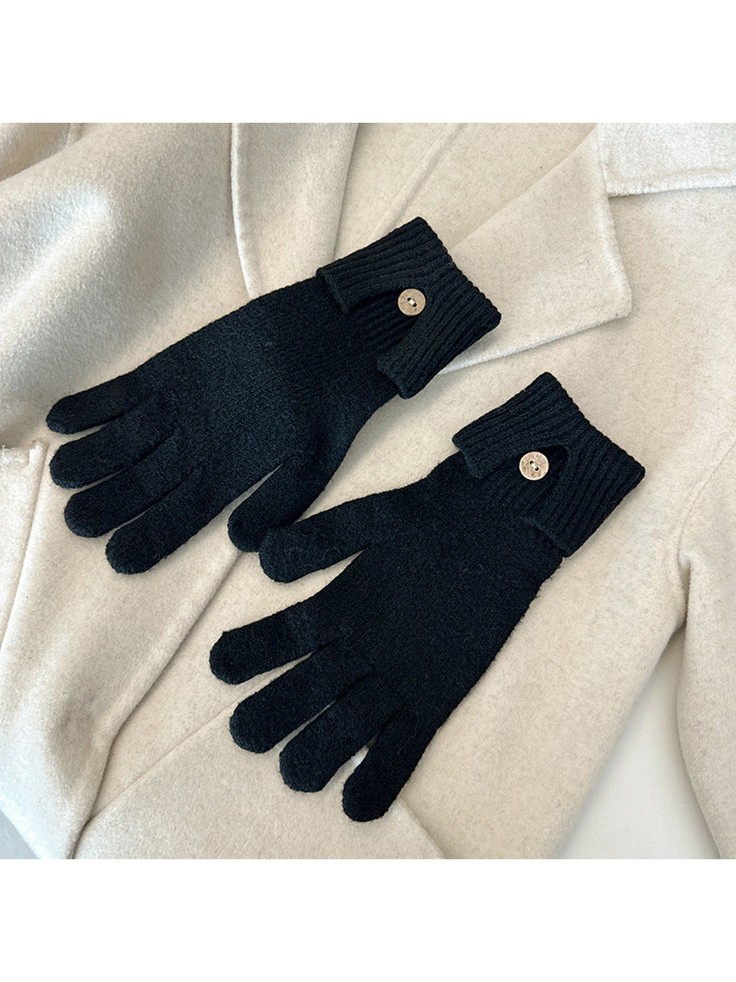 Black gloves with ribbed cuffs and button details