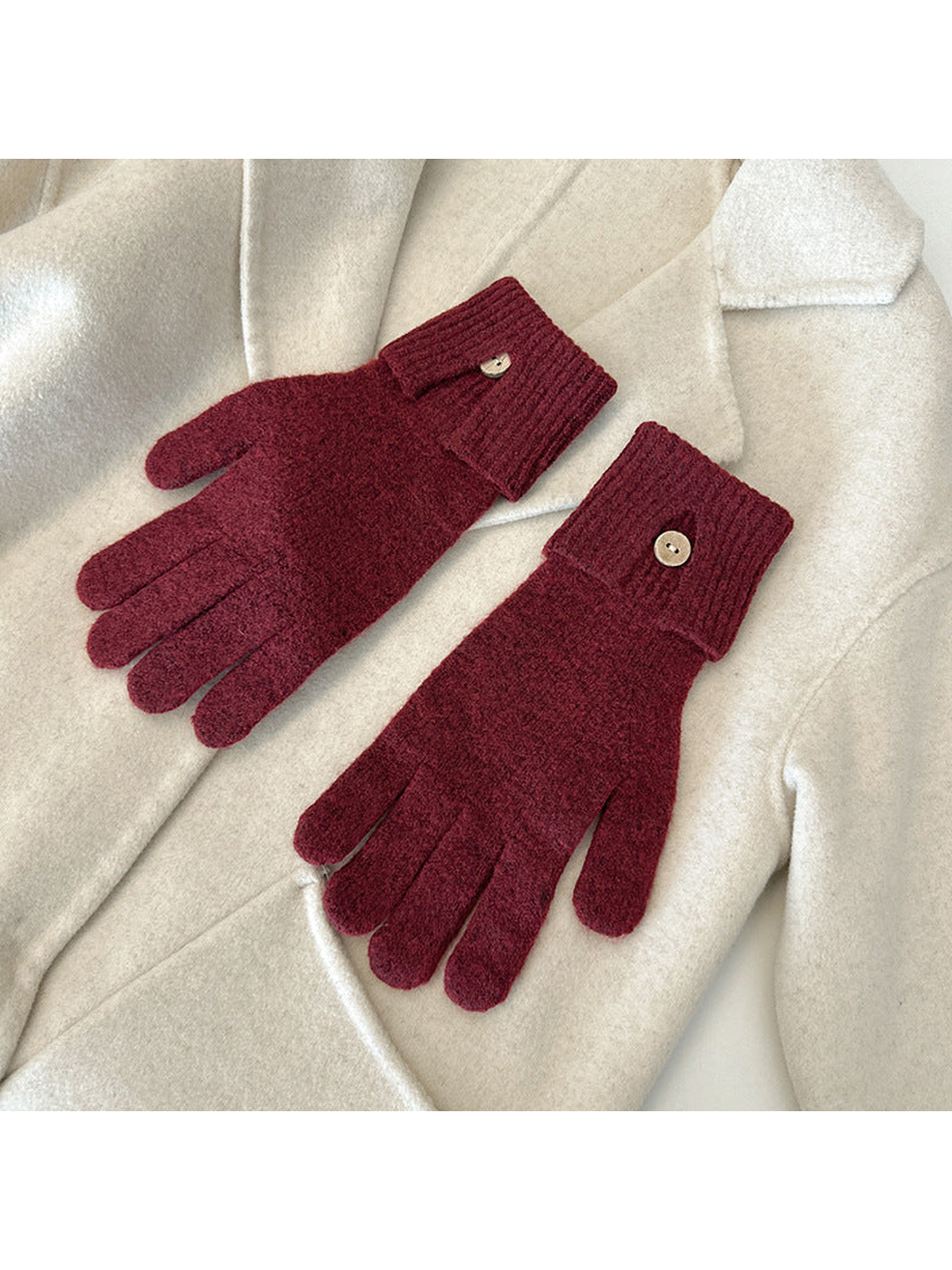 Burgundy gloves with ribbed cuffs and button details