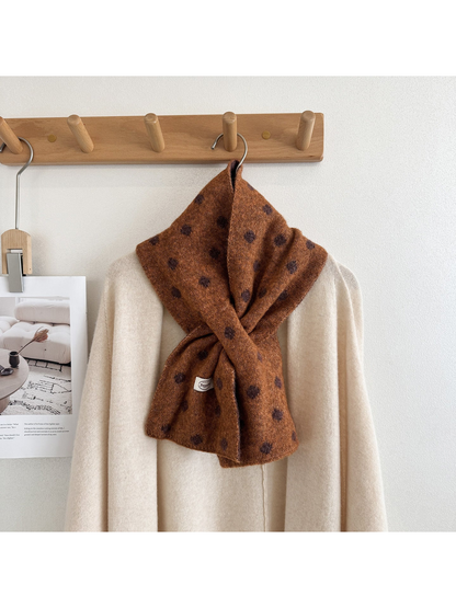 Caramel polka-dot scarf styled around a cream sweater