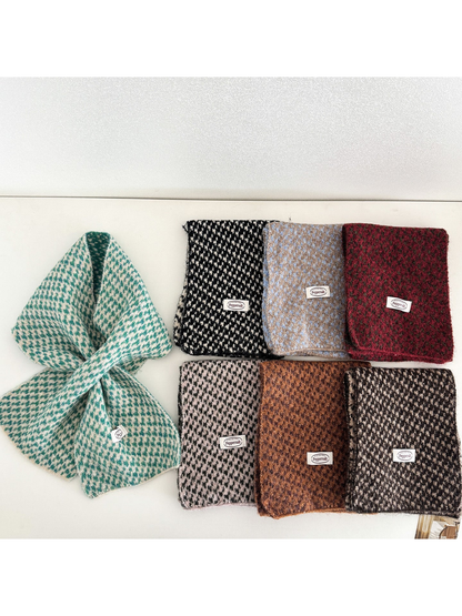Multiple colors of a patterned narrow scarf displayed together