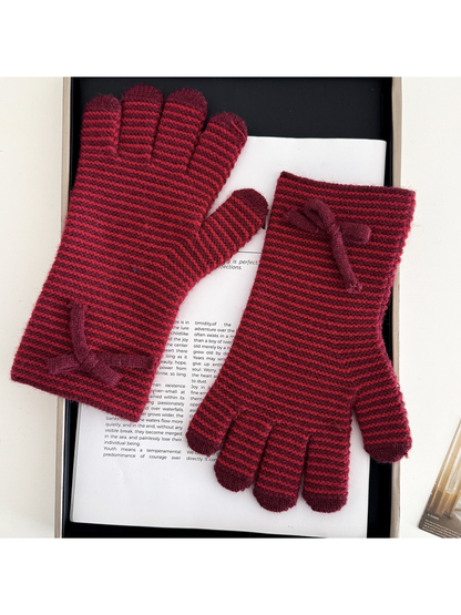Red gloves with burgundy stripes and bow details