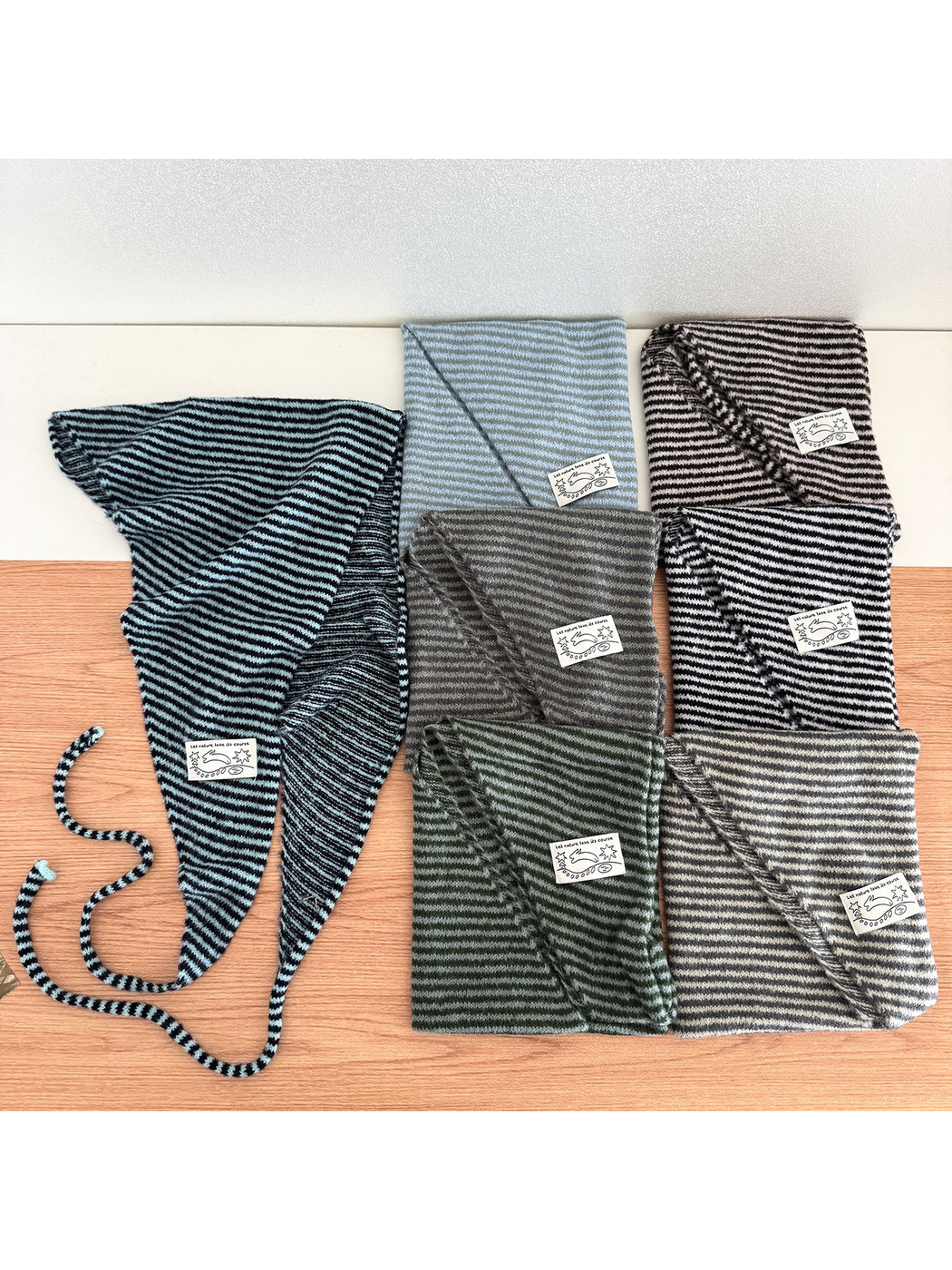 Multiple striped triangle scarves displayed together