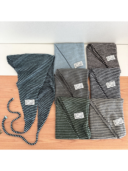 Multiple striped triangle scarves displayed together