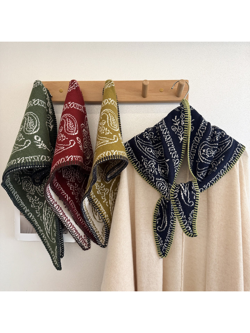 Multiple scarf colors displayed on a wall rack