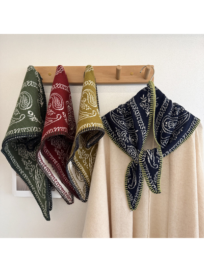 Multiple scarf colors displayed on a wall rack