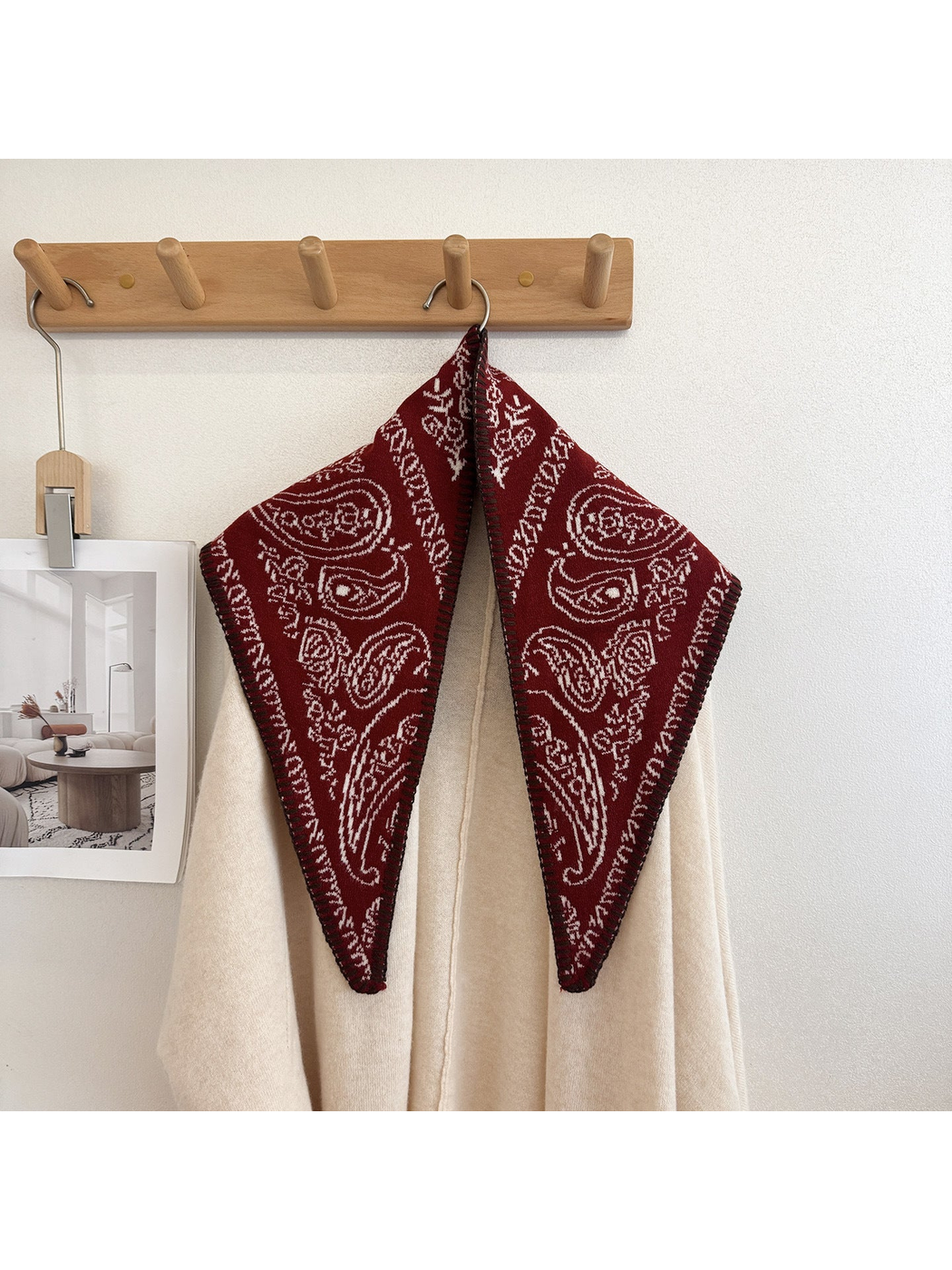 Burgundy paisley scarf draped over a cream sweater