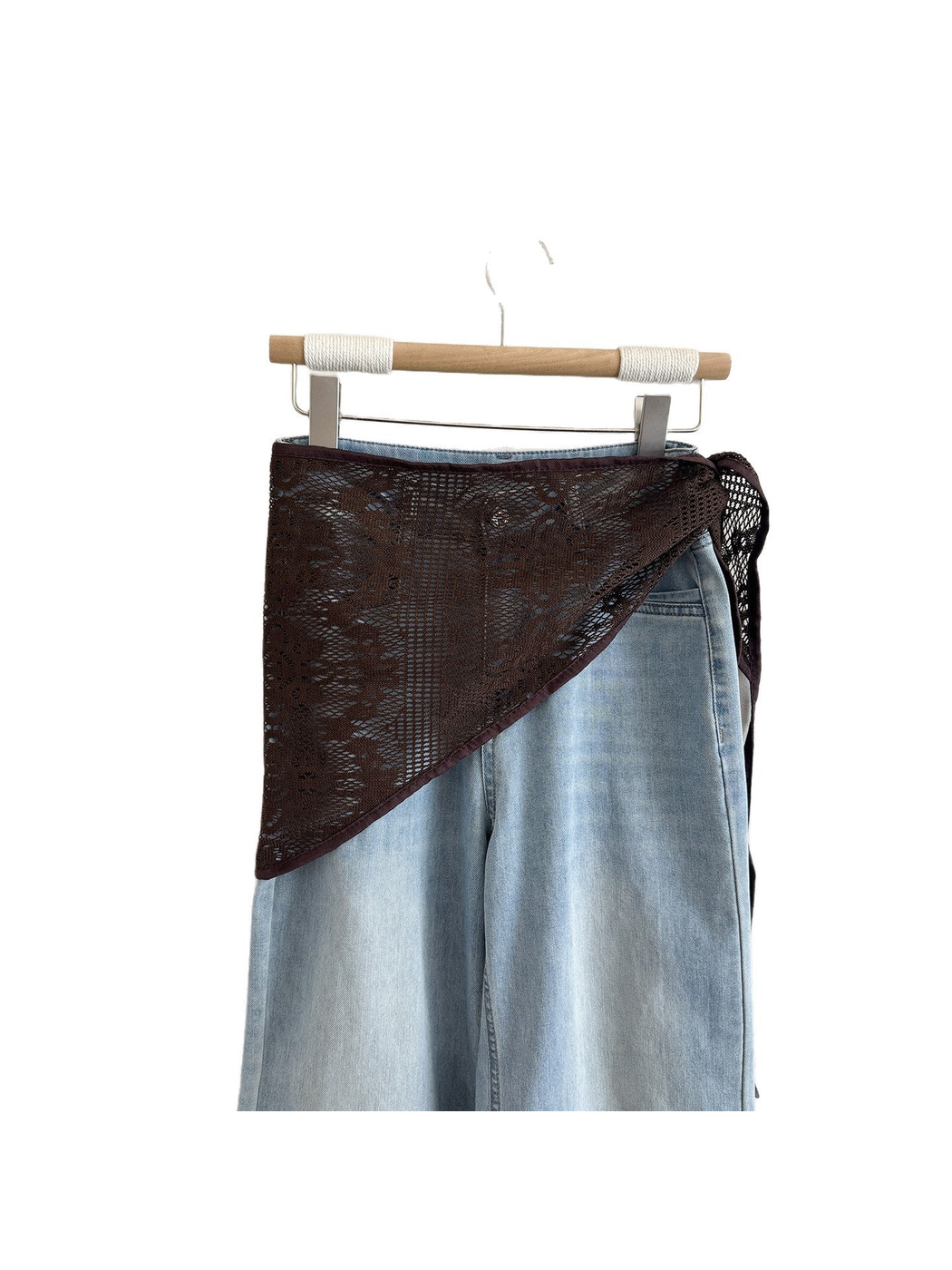 Coffee lace triangle scarf displayed over light denim