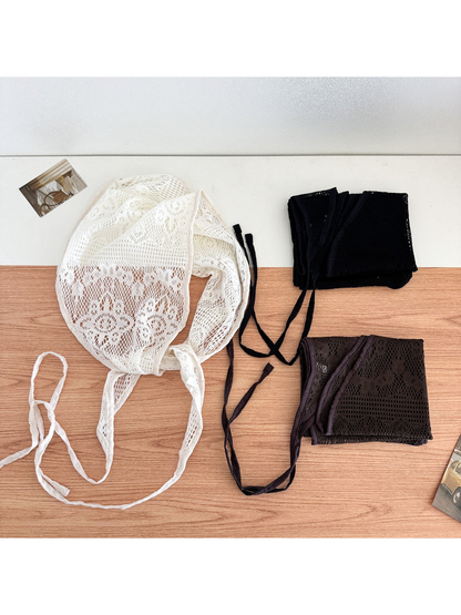 Black, white, and coffee lace triangle scarves displayed together