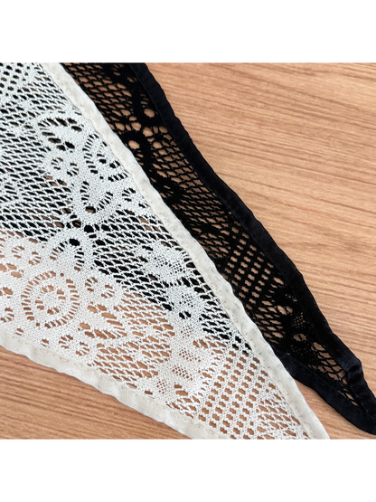 Close-up of white and black lace scarf textures
