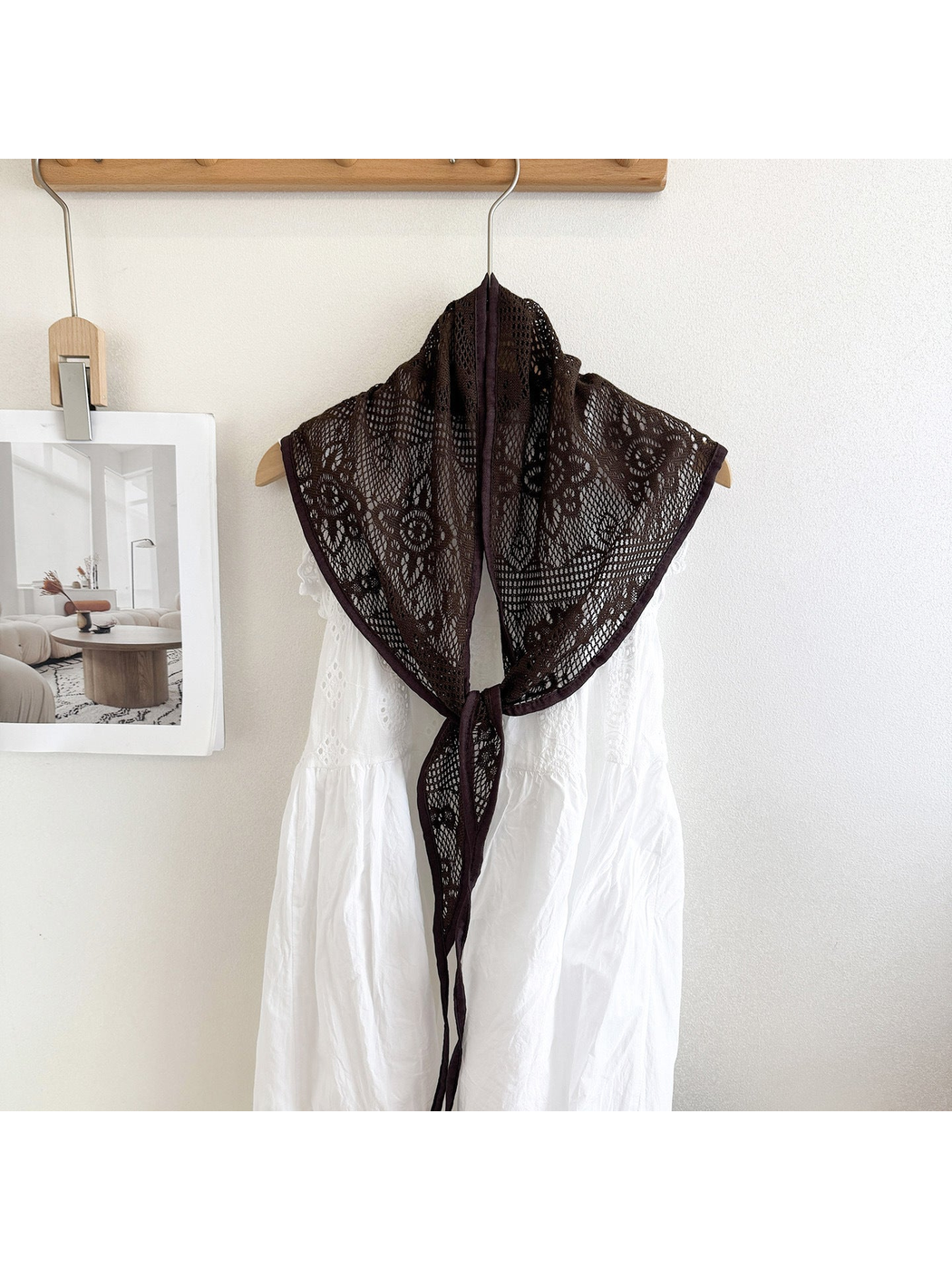 Coffee lace triangle scarf draped over a white dress