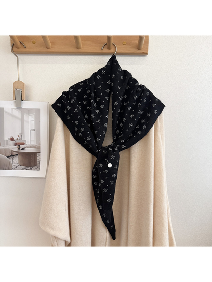 Black scarf with small floral motifs, tied display