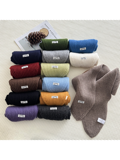 Ribbed knit scarves in multiple colors arranged in rolled and folded views