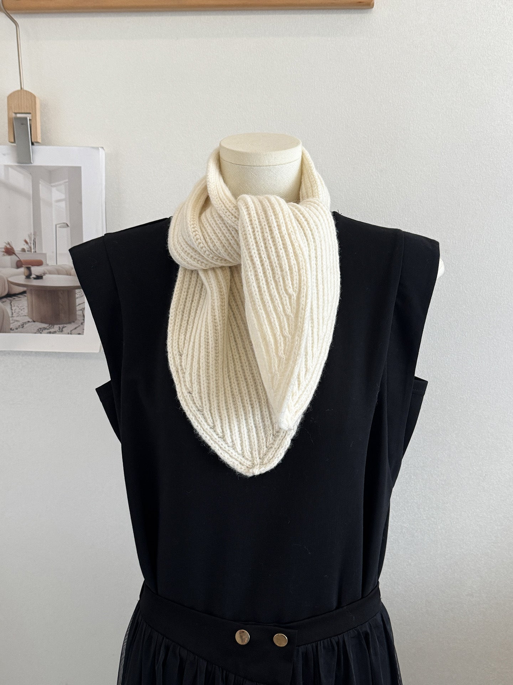 Ivory ribbed knit scarf with pointed ends on a mannequin