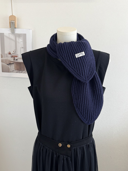 Navy ribbed knit scarf with pointed ends on a mannequin