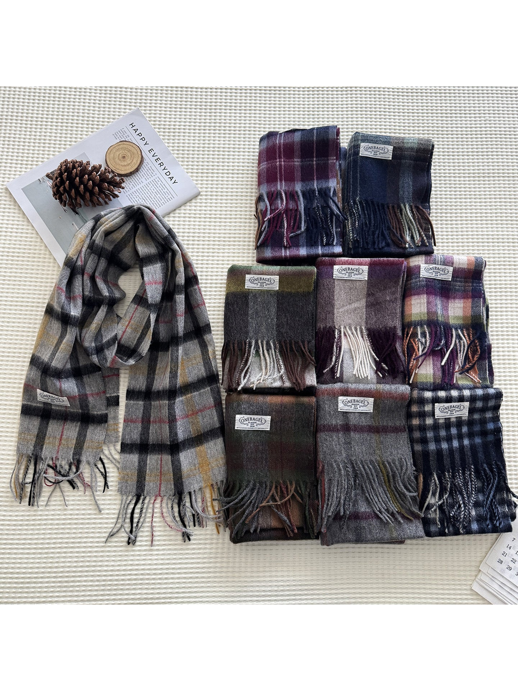 Multiple plaid scarves displayed together in a tabletop arrangement