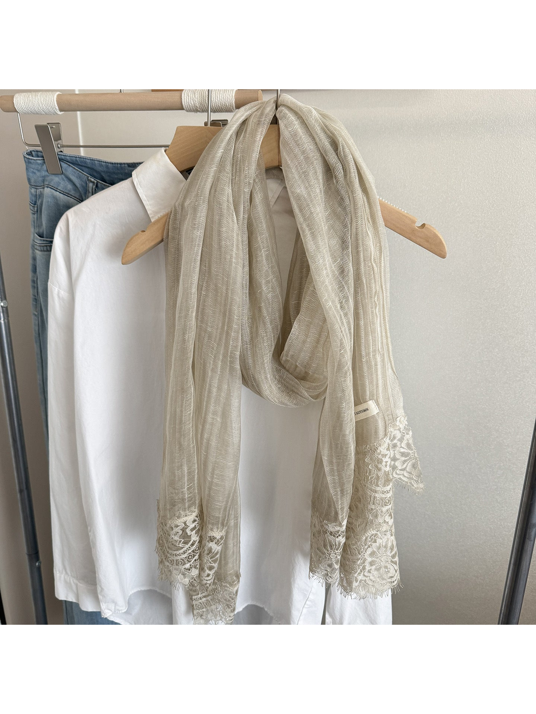 Greige narrow scarf with floral lace trim, hanging display