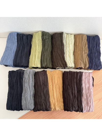 Multiple color-block scarves arranged in two rows