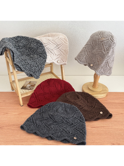 Multiple cable-knit beanies displayed together