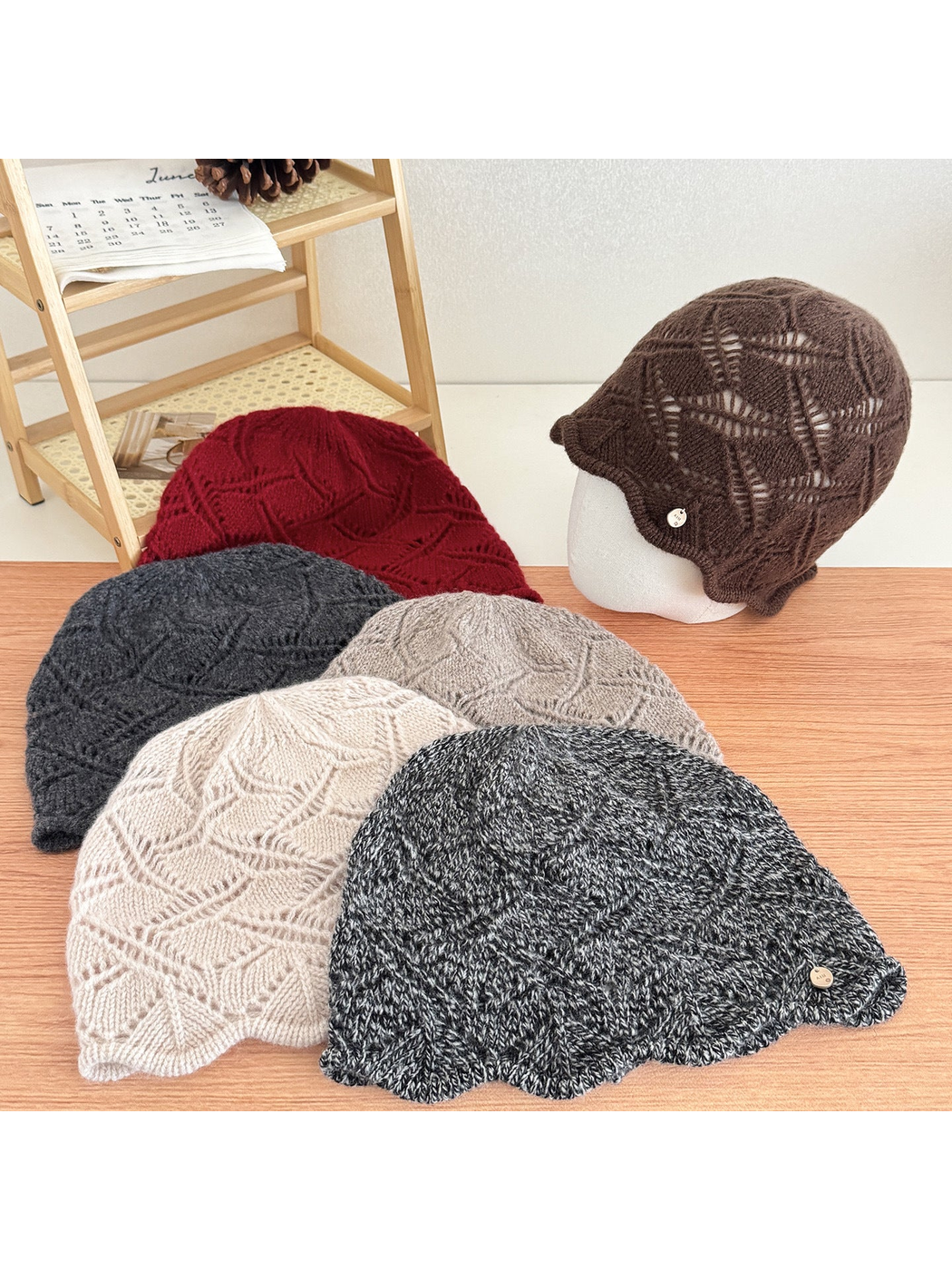 Multiple cable-knit beanies displayed together in assorted colors