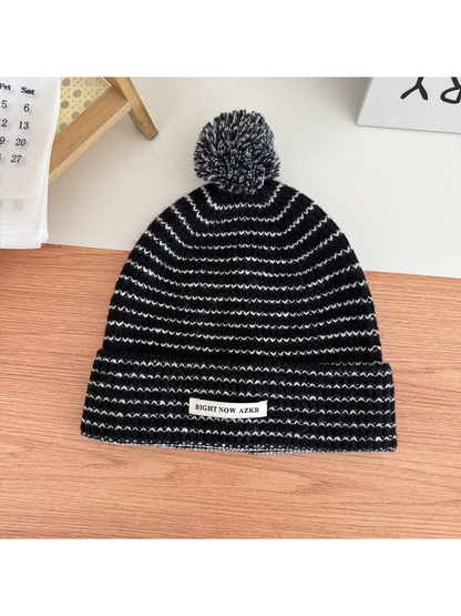 Black pom-pom beanie with wavy stripes and folded cuff