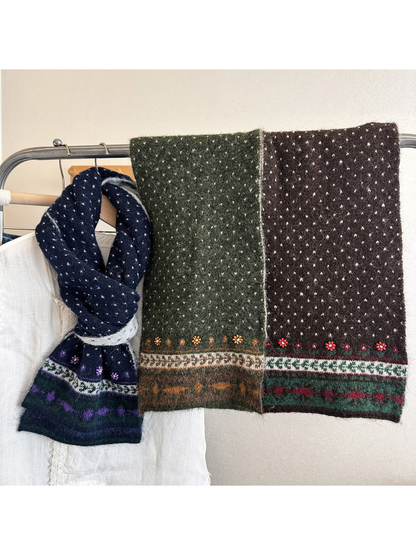 Multiple patterned scarf styles displayed together in looped and flat arrangements.