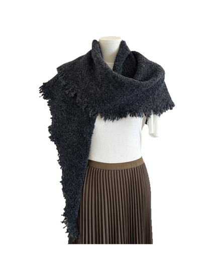 Charcoal textured scarf with fringed edges draped on a mannequin