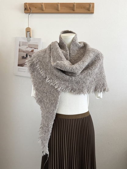 Khaki textured scarf with fringed edges draped on a mannequin