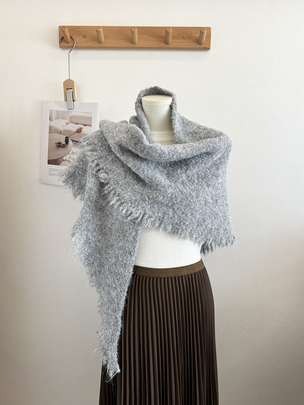 Light Gray textured scarf with fringed edges draped on a mannequin