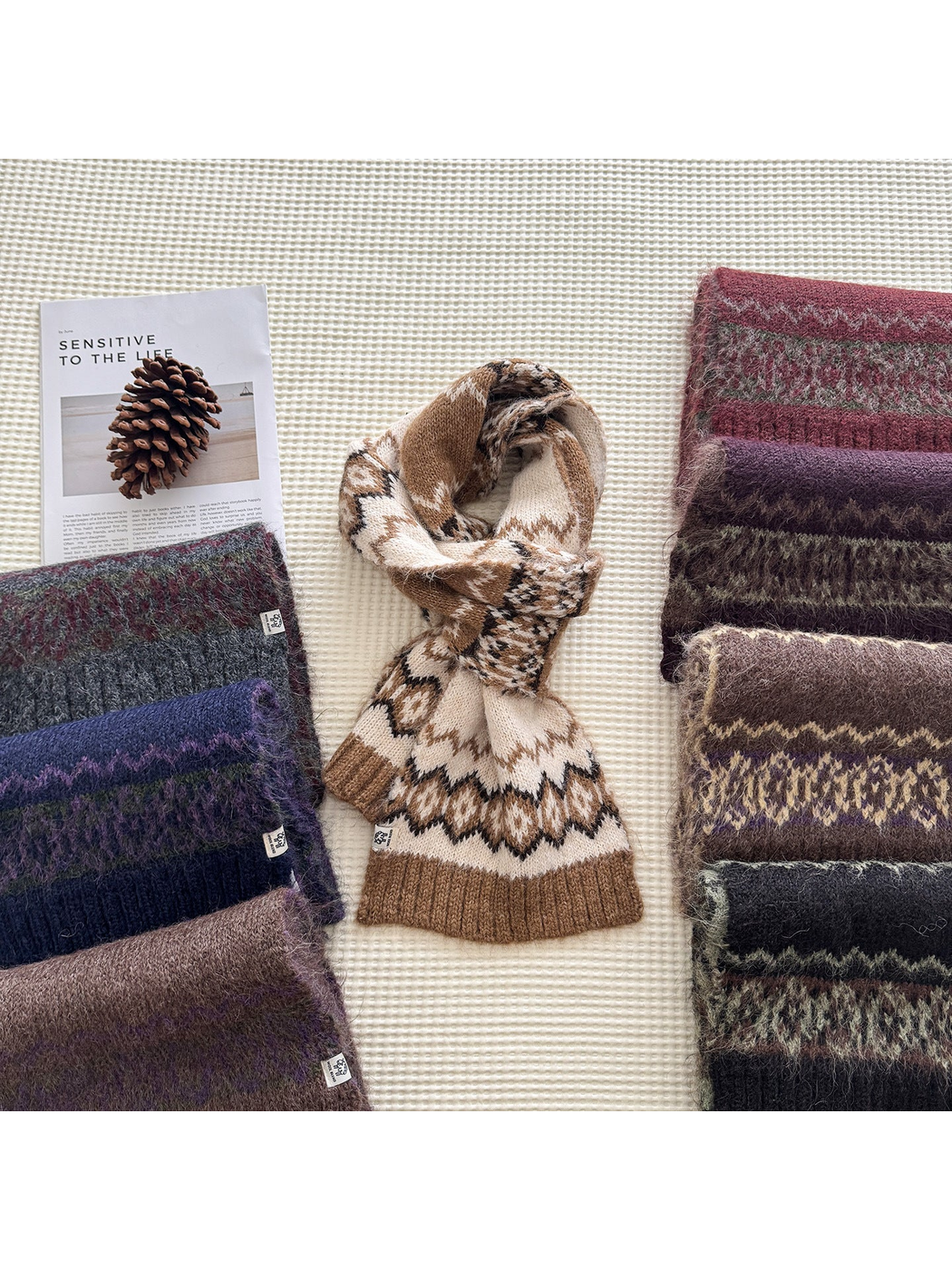 Multiple patterned scarves arranged on a textured surface