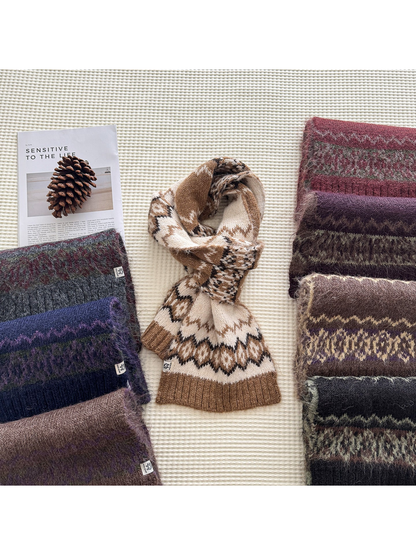 Multiple patterned scarves arranged on a textured surface