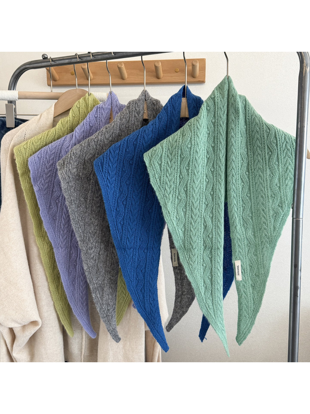 Multiple colors of textured triangle scarves displayed together
