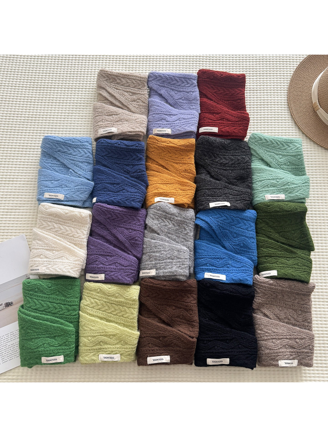 Triangle scarves in multiple colors folded and arranged together