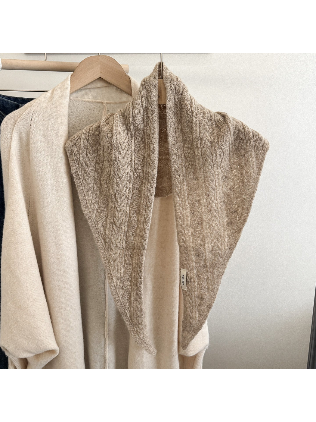 Beige textured triangle scarf displayed front-facing