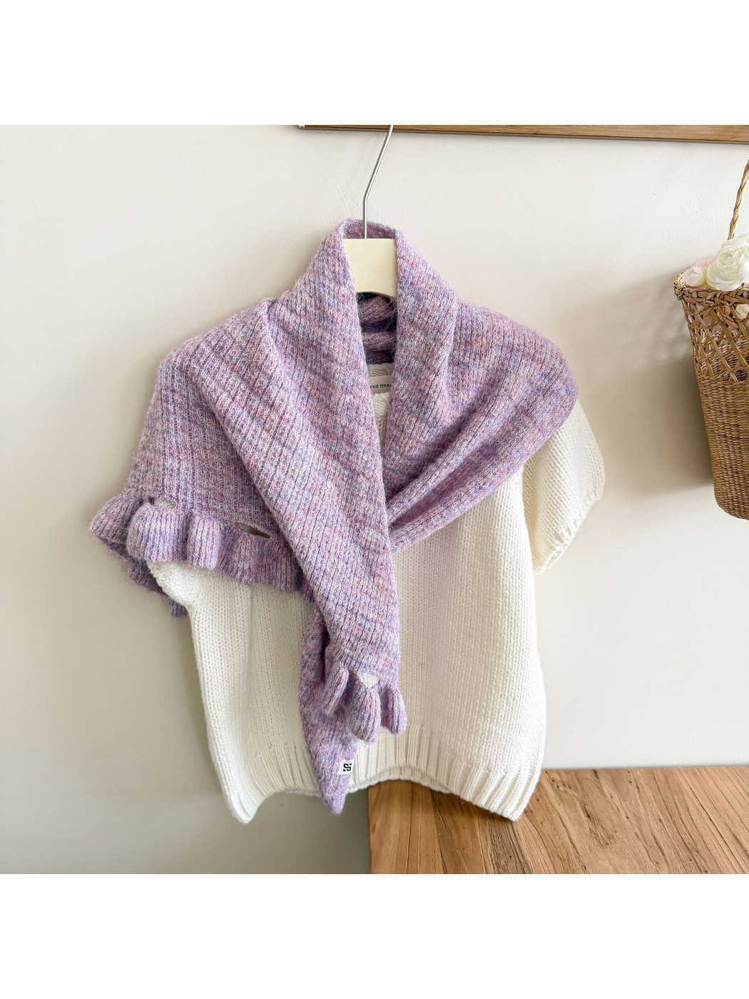 Blush Pink triangle scarf draped over a white sweater on a hanger