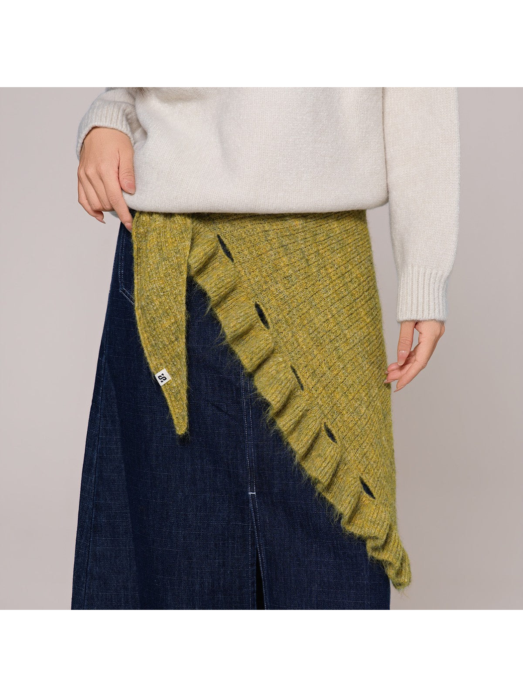 Mustard Yellow triangle scarf tied around the waist over dark denim