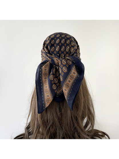 Navy geometric-pattern scarf wrapped over the head, back view