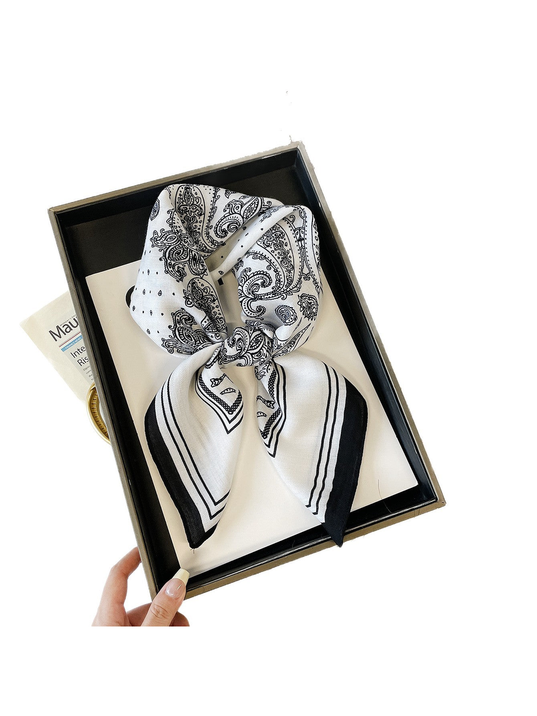 White paisley scarf tied in a bow inside a box