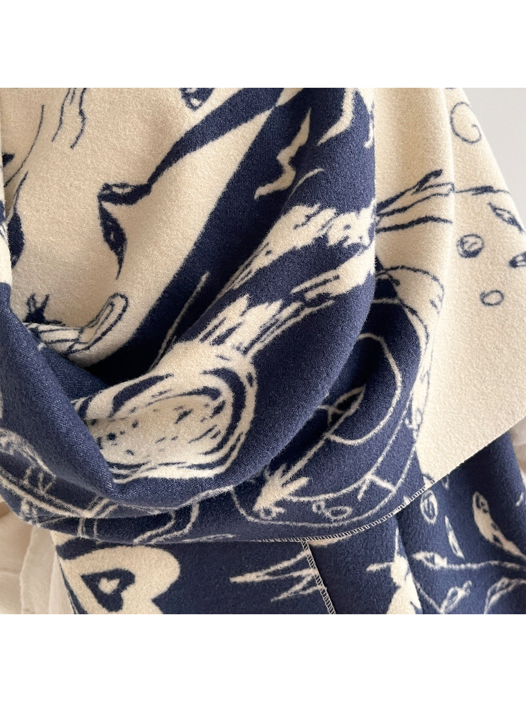 Close-up of the scarf's abstract print and textured surface