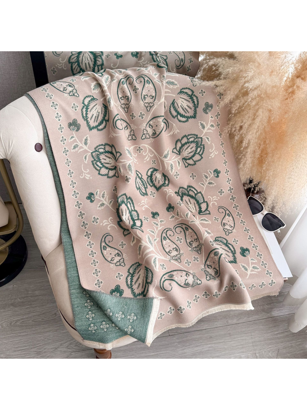 Dusty Pink floral and paisley scarf draped over a chair, with a contrasting reverse side and fringed edges
