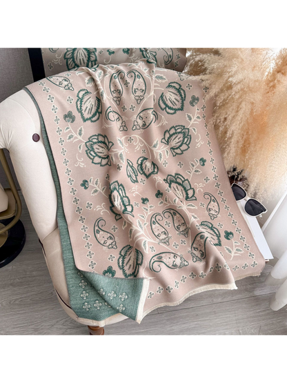 Dusty Pink floral and paisley scarf draped over a chair, with a contrasting reverse side and fringed edges