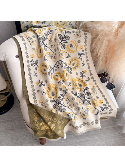 Mustard Yellow floral and paisley scarf draped over a chair, with a contrasting reverse side and fringed edges